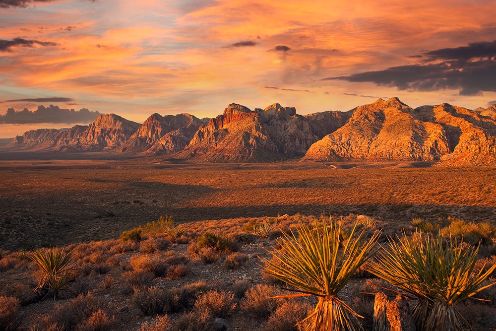 Orange first rays of dawn light on the cliffs of Red Rock Canyon National Conservation Area nea Las Vegas Nevada.